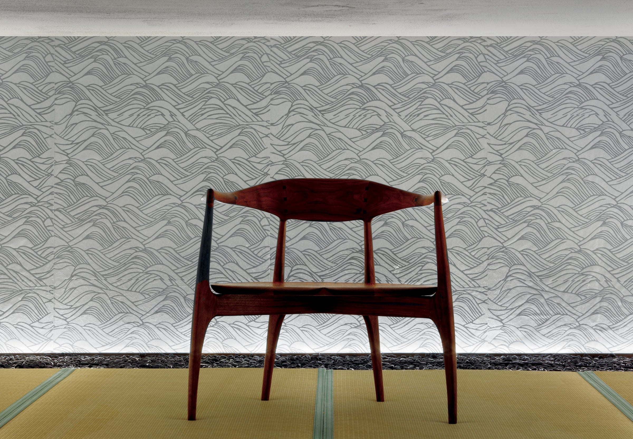 Wooden chair on tatami in front of a white wave-pattern wallcovering